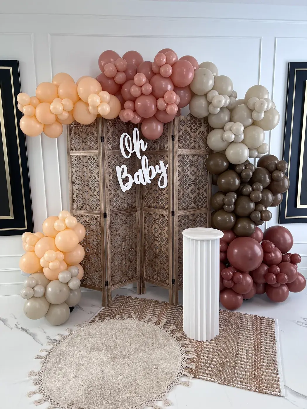 Oh Baby neon on rattan screens with a terracotta, peach and cream garland