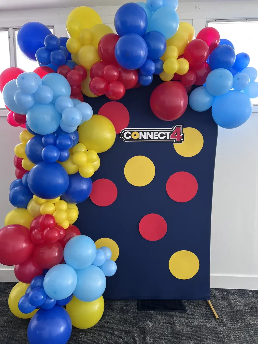 Navy spotted Connect backdrop with a primary colour garland in red, yellow and blue