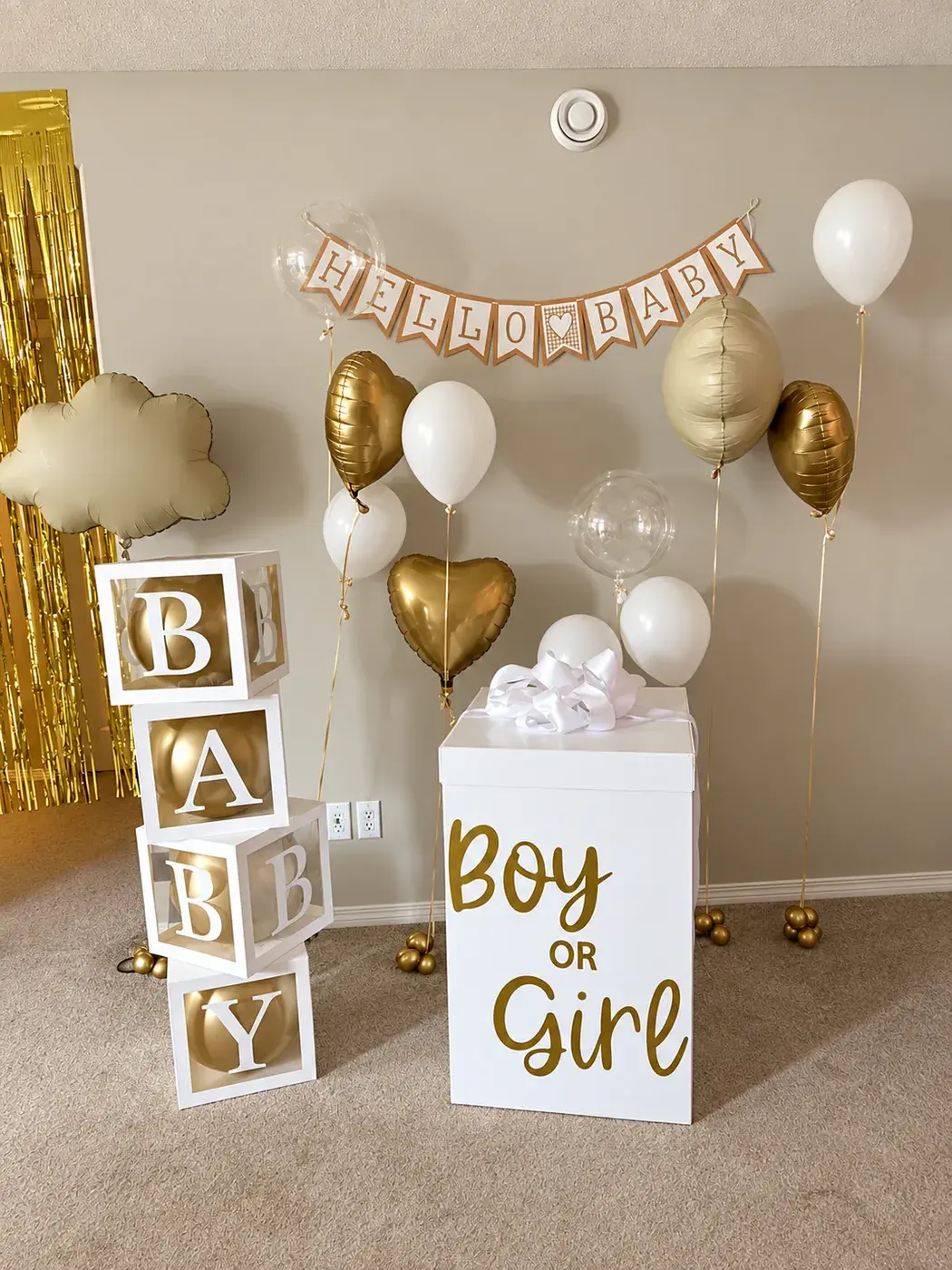 Boy or Girl reveal box with lettered blocks, a Hello Baby banner and gold hearts