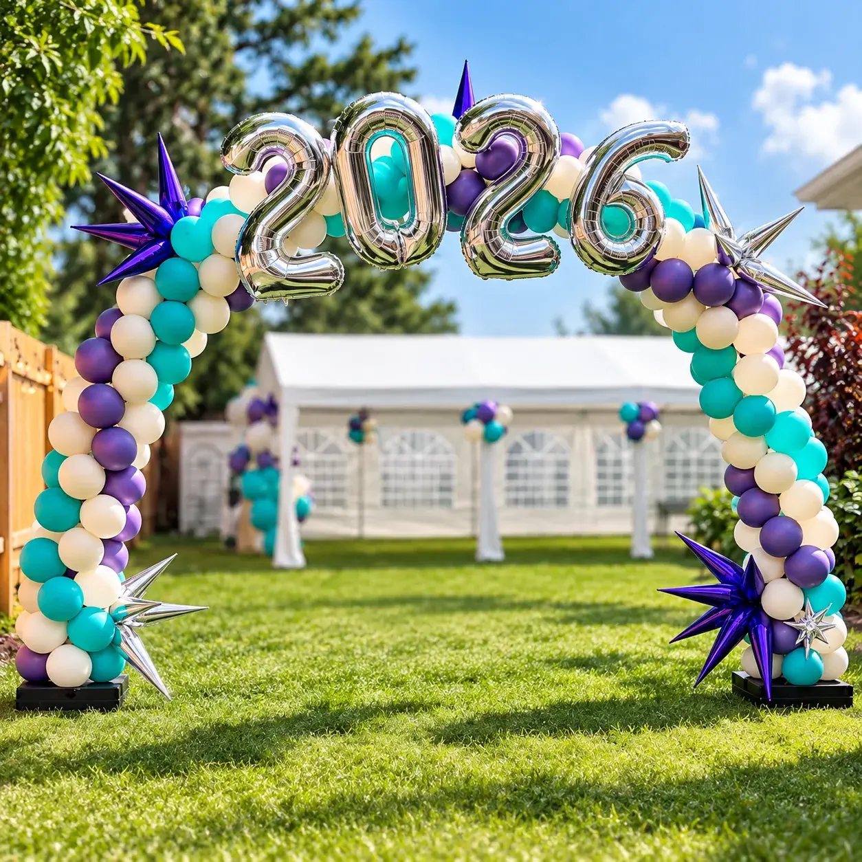 Walk-through balloon arch with a silver 2026 in foil and chrome star bursts