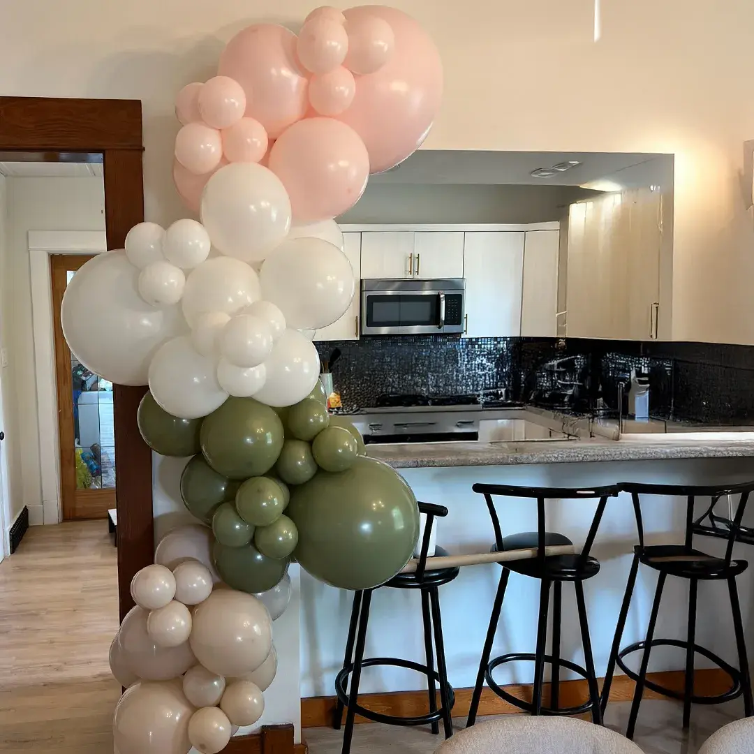 Sage, blush and cream garland framing a kitchen doorway